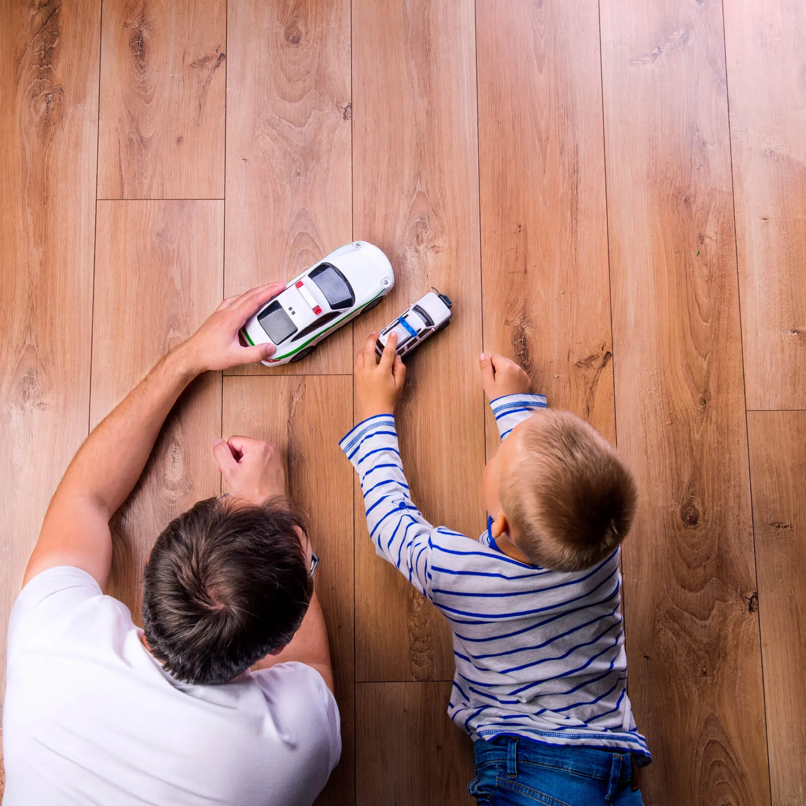 Dad and Child Playing On Flooring | Jabara's